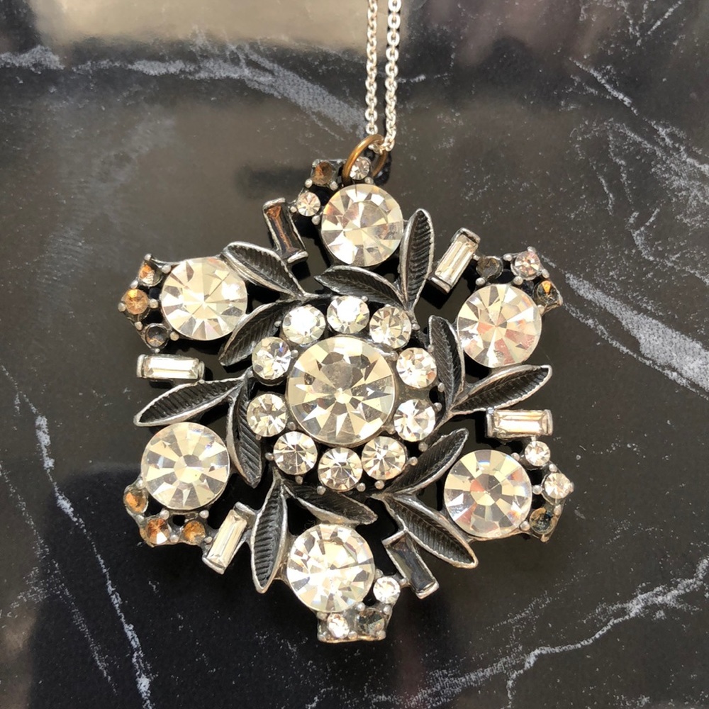 Snowflake pendant on silver tone chain
